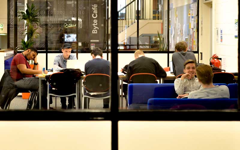 students sat at a table in a cafe