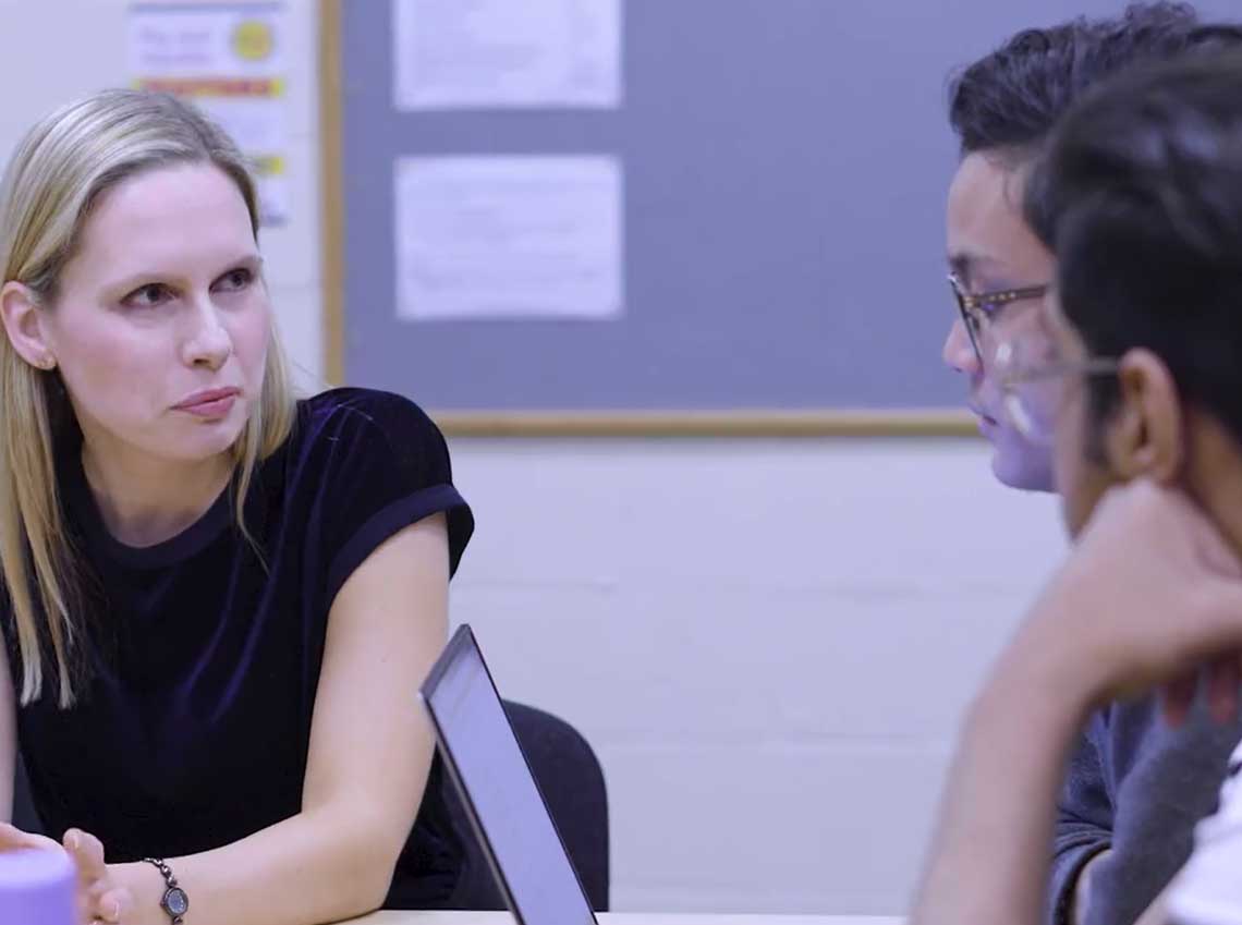 meeting at a table with three people