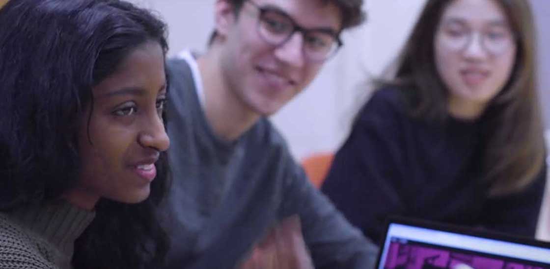 Three students smiling